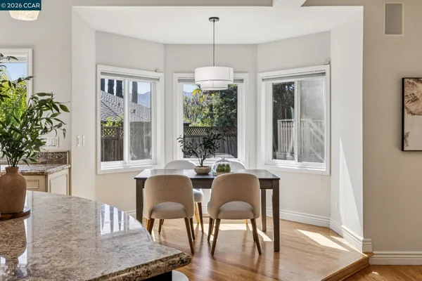 a bathroom with a granite countertop sink a toilet and a large mirror