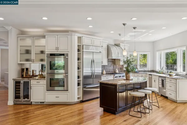 a living room with furniture large window and wooden floor