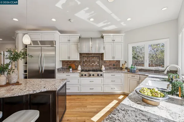a view of a dining room with furniture wooden floor and chandelier