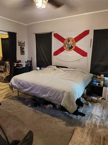 a bedroom with a bed and a large mirror