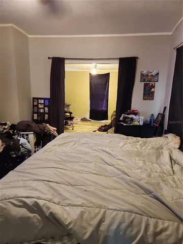 a bedroom with furniture and a wooden floor