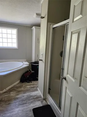 a bathroom with a granite countertop toilet and a shower