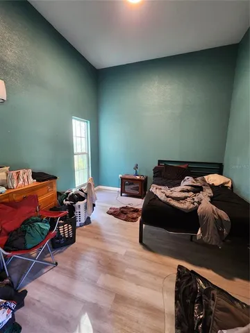 a room with wooden floor and furniture