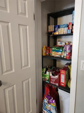 a living room with furniture a flat screen tv and gym equipment
