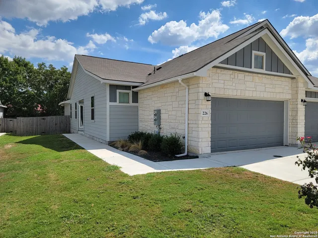 a front view of house with yard and green space