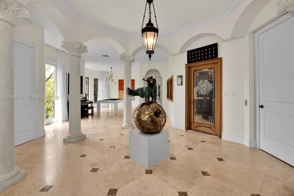 a living room with stainless steel appliances furniture and a kitchen