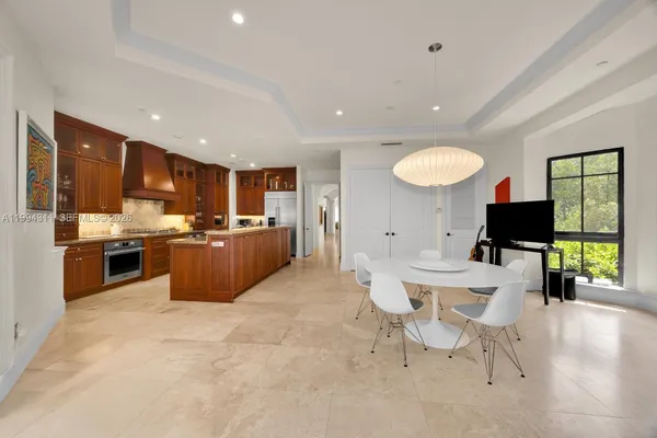a kitchen with granite countertop a sink stove and cabinets