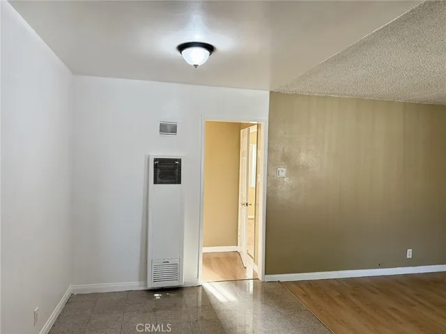 an empty room with wooden floor and closet
