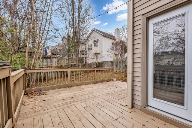 a view of a backyard with wooden fence