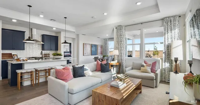 a living room with furniture kitchen and a table
