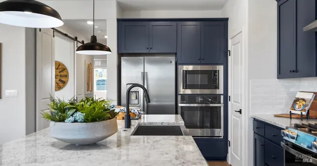 a view of a kitchen with a potted plant and a large window