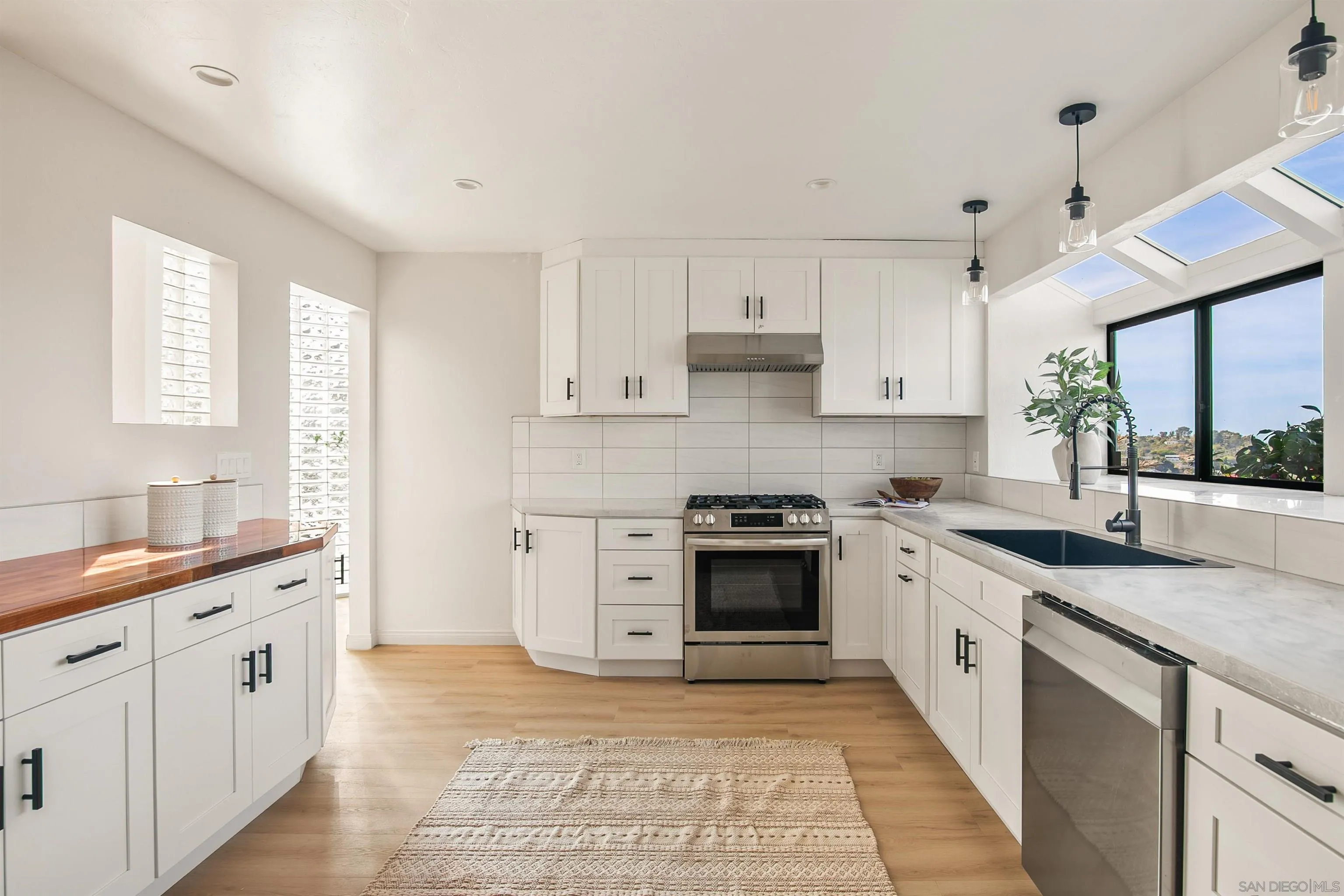 1050 Solana Drive Del Mar, CA 92014 - Photo 18 of 75 a large kitchen with stainless steel appliances granite countertop a stove sink and cabinets