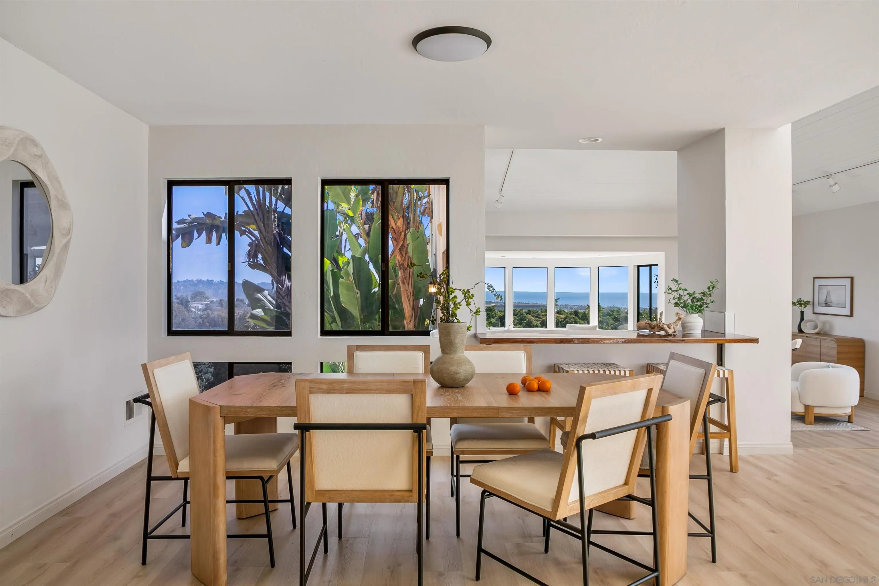 1050 Solana Drive Del Mar, CA 92014 - Photo 20 of 75 a dining room with wooden floor a glass table and chairs