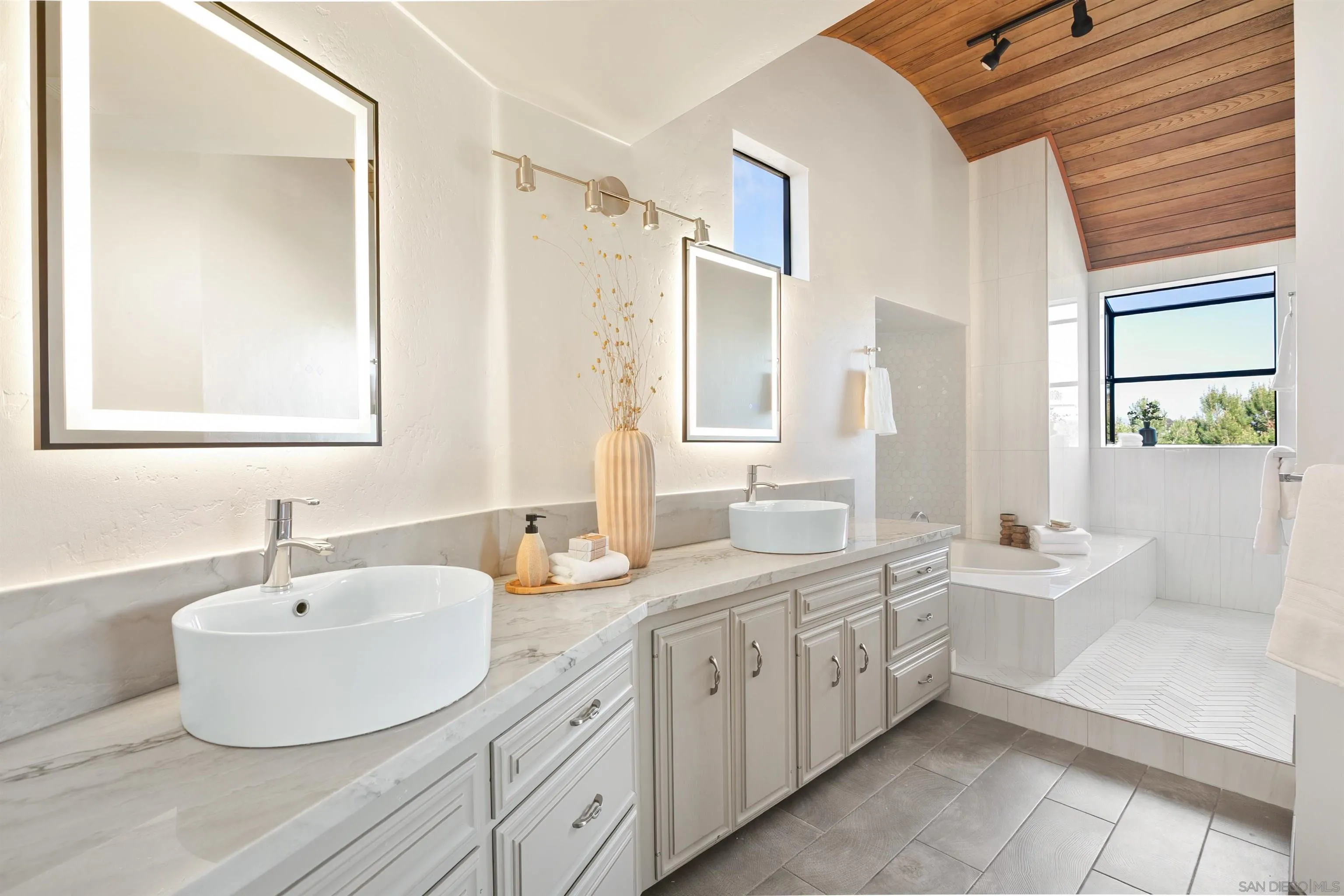 1050 Solana Drive Del Mar, CA 92014 - Photo 28 of 75 a bathroom with a double vanity sink a mirror and a bathtub