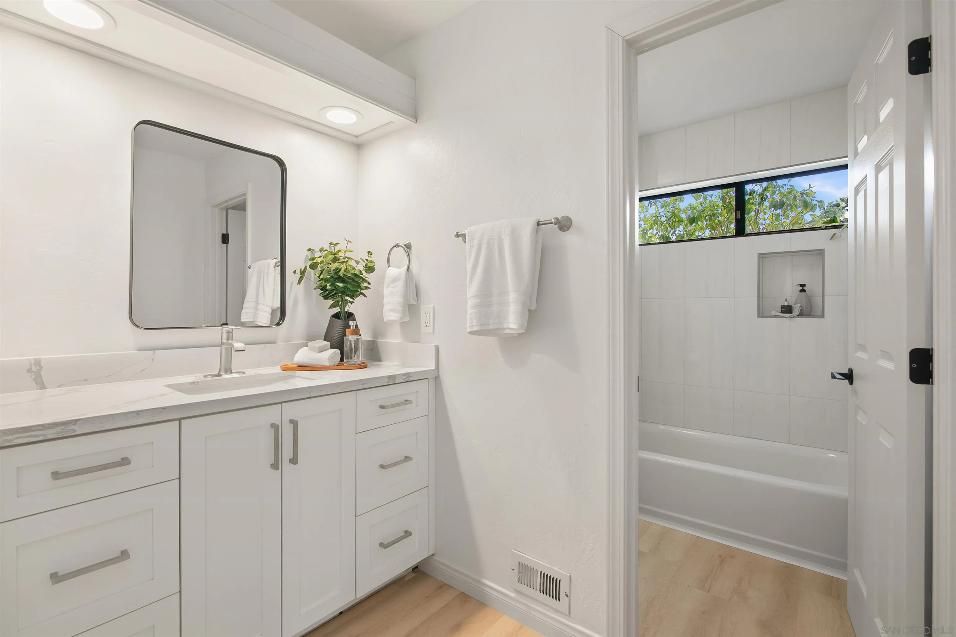 1050 Solana Drive Del Mar, CA 92014 - Photo 34 of 75 a bathroom with a double vanity sink and mirror