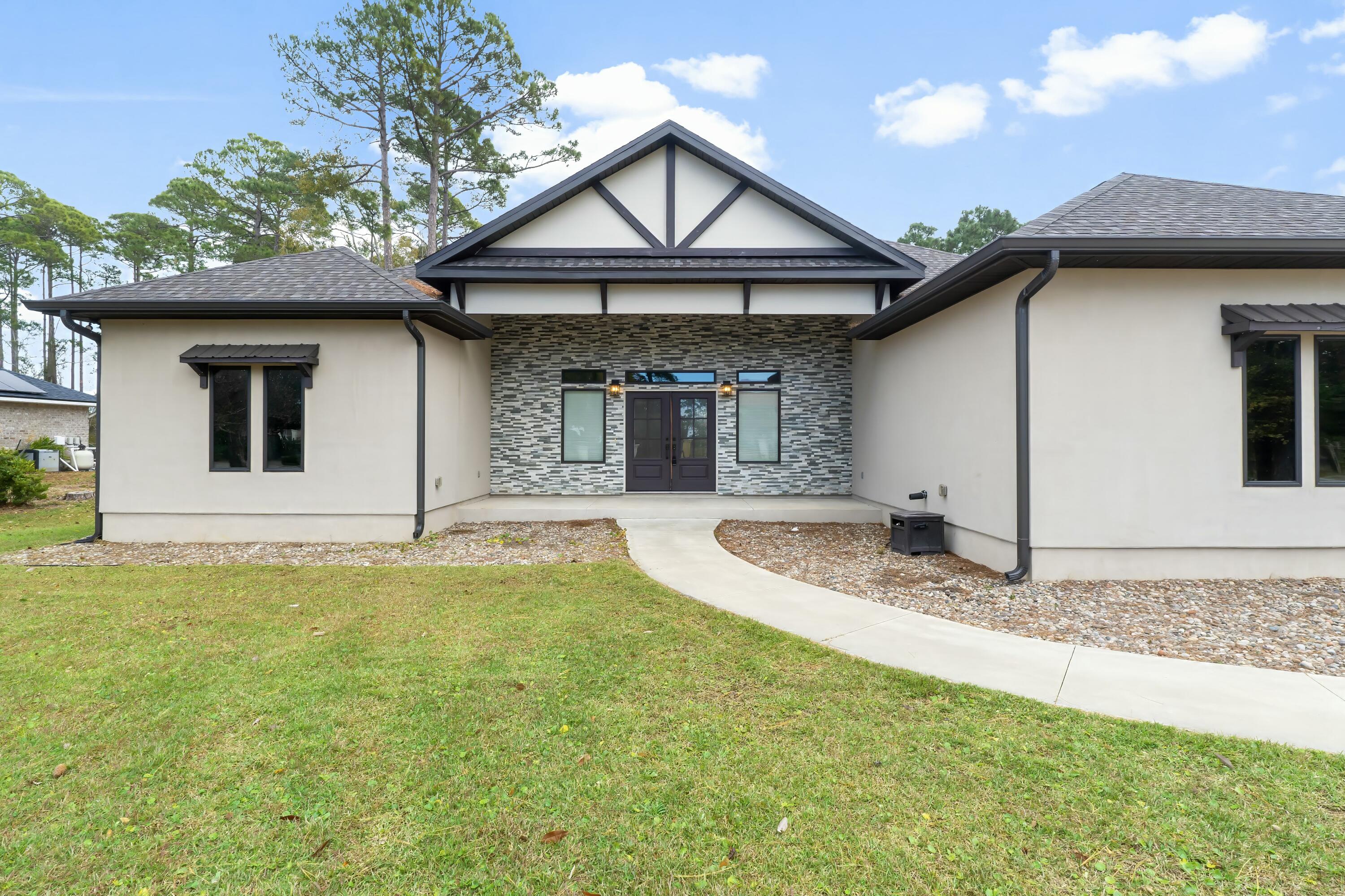 158 Driftwood Point Road Santa Rosa Beach, FL 32459 - Photo 1 of 24 a front view of a house with garden