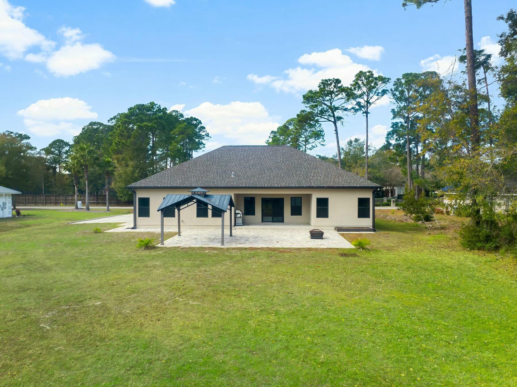 158 Driftwood Point Road Santa Rosa Beach, FL 32459 - Photo 23 of 24 a white house that has a big yard