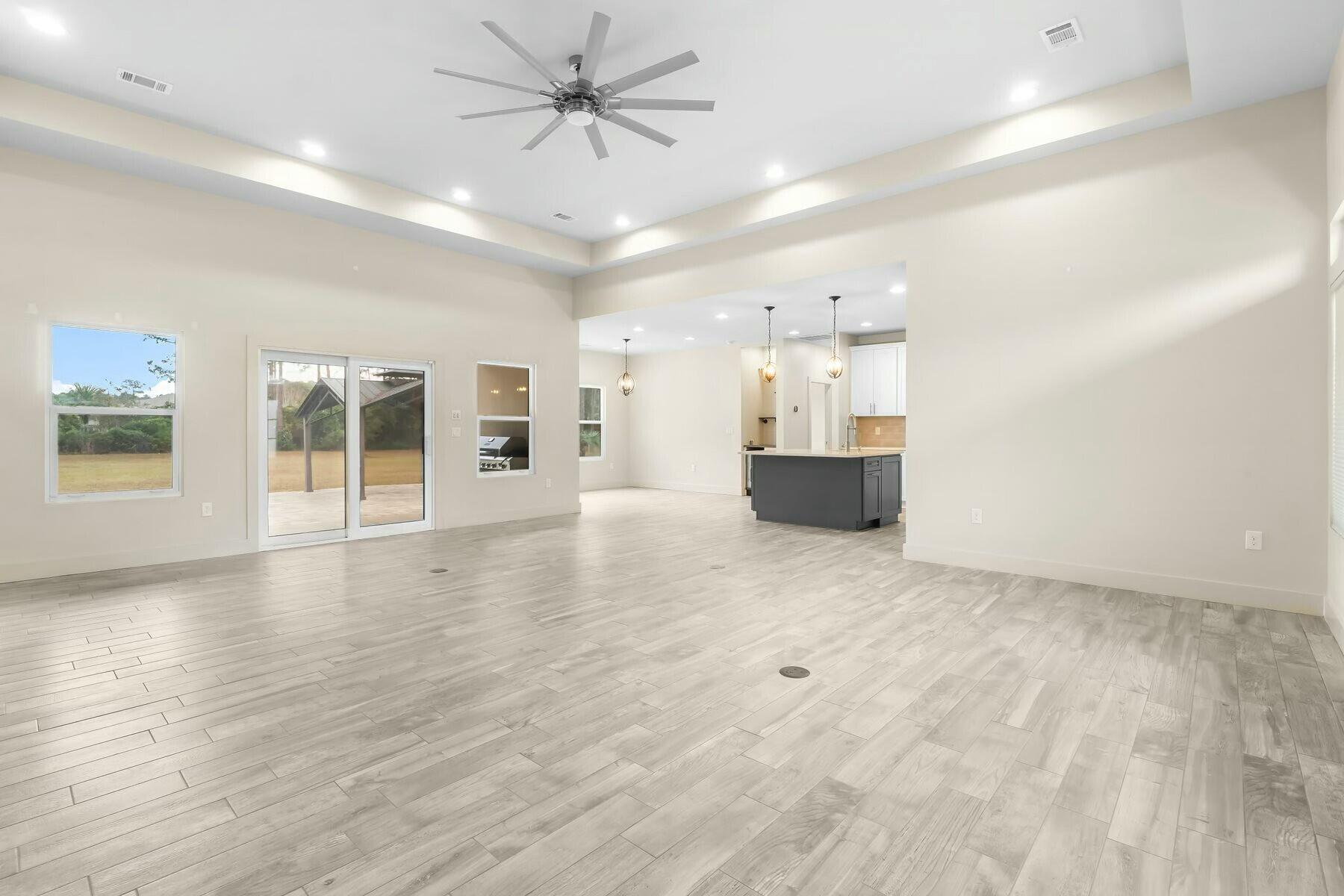 158 Driftwood Point Road Santa Rosa Beach, FL 32459 - Photo 7 of 24 an empty room with wooden floor and windows