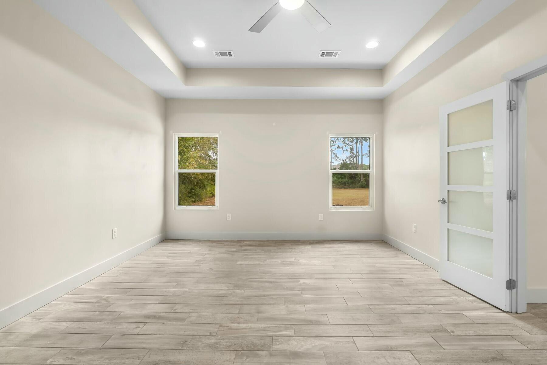 158 Driftwood Point Road Santa Rosa Beach, FL 32459 - Photo 10 of 24 an empty room with wooden floor and windows