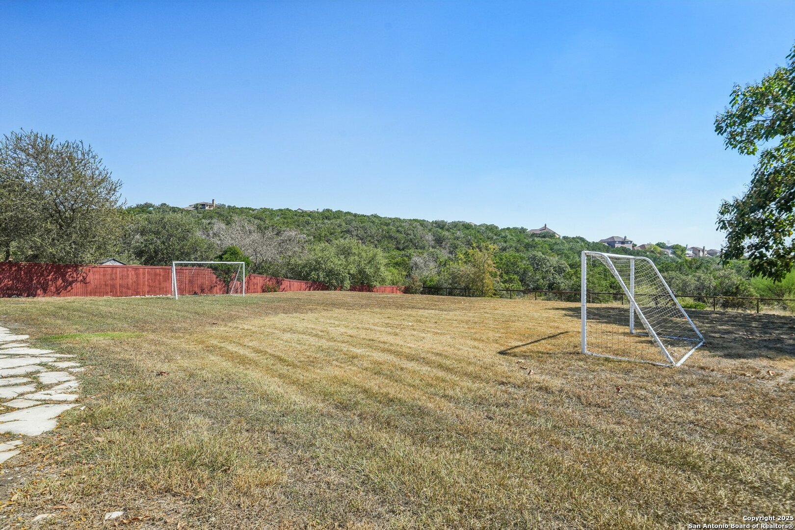 718 Ruidosa Downs Helotes, TX 78023 - Photo 4 of 50 a view of a field with trees in the background