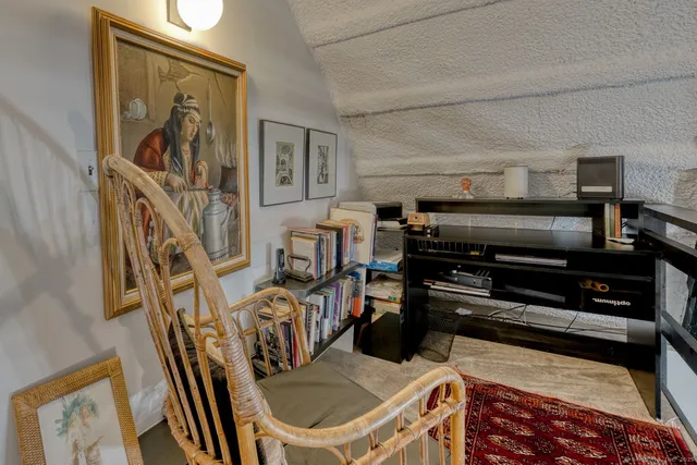 a view of a livingroom with furniture and staircase