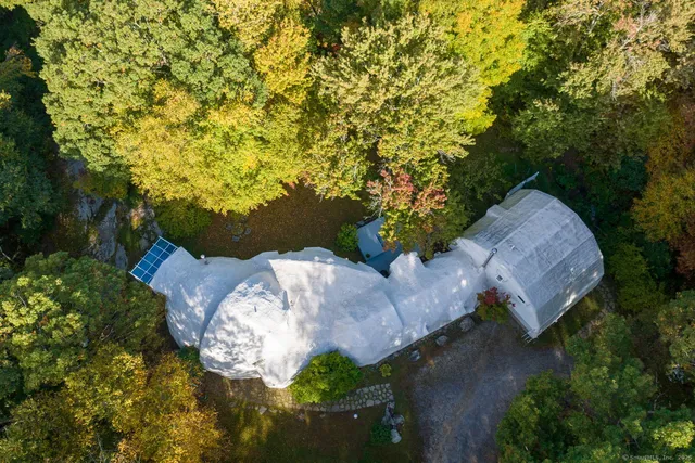 an aerial view of a house with yard swimming pool and outdoor seating
