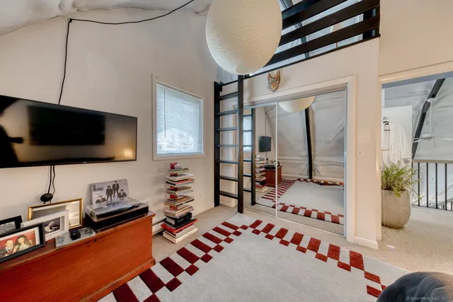 a view of a room with a ceiling fan