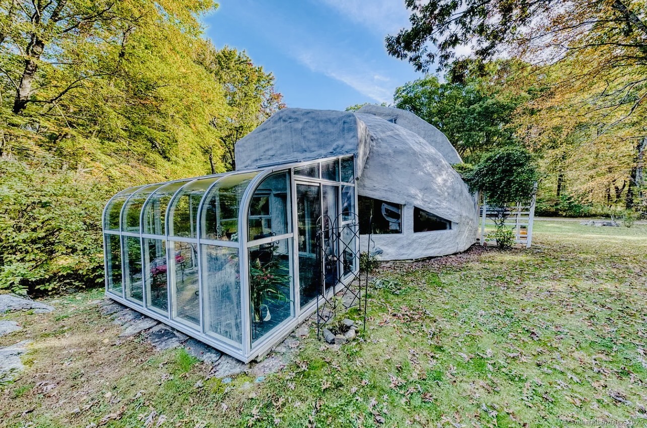 11 Day Road Cornwall, CT 06754 - Photo 7 of 40 a view of house with large trees and flower plants in front of main door
