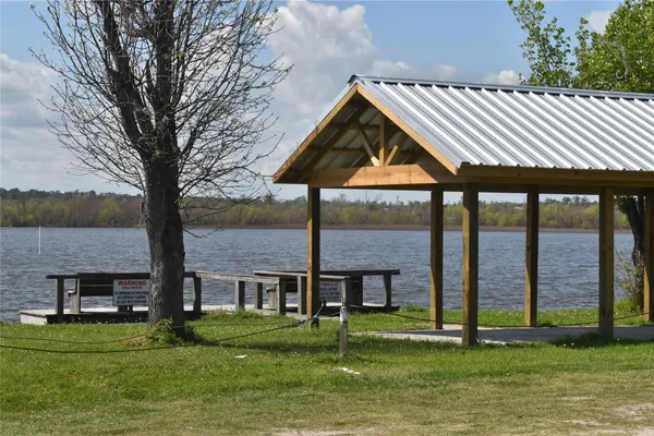 a backyard of a house with barbeque oven and a fountain