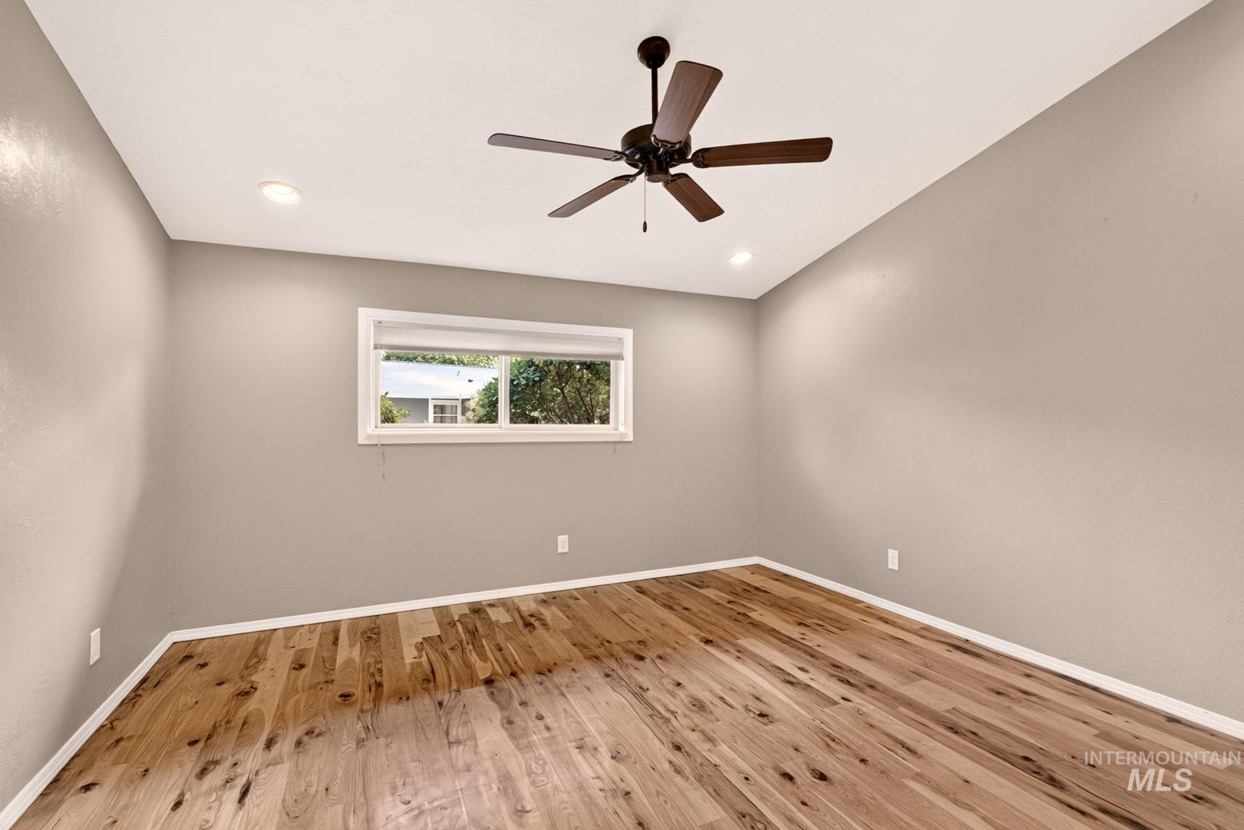 9622 Delaware Street Boise, ID 83709 - Photo 23 of 48 Room featuring wood-finish flooring, recessed lighting, a ceiling fan, and a window with white trim