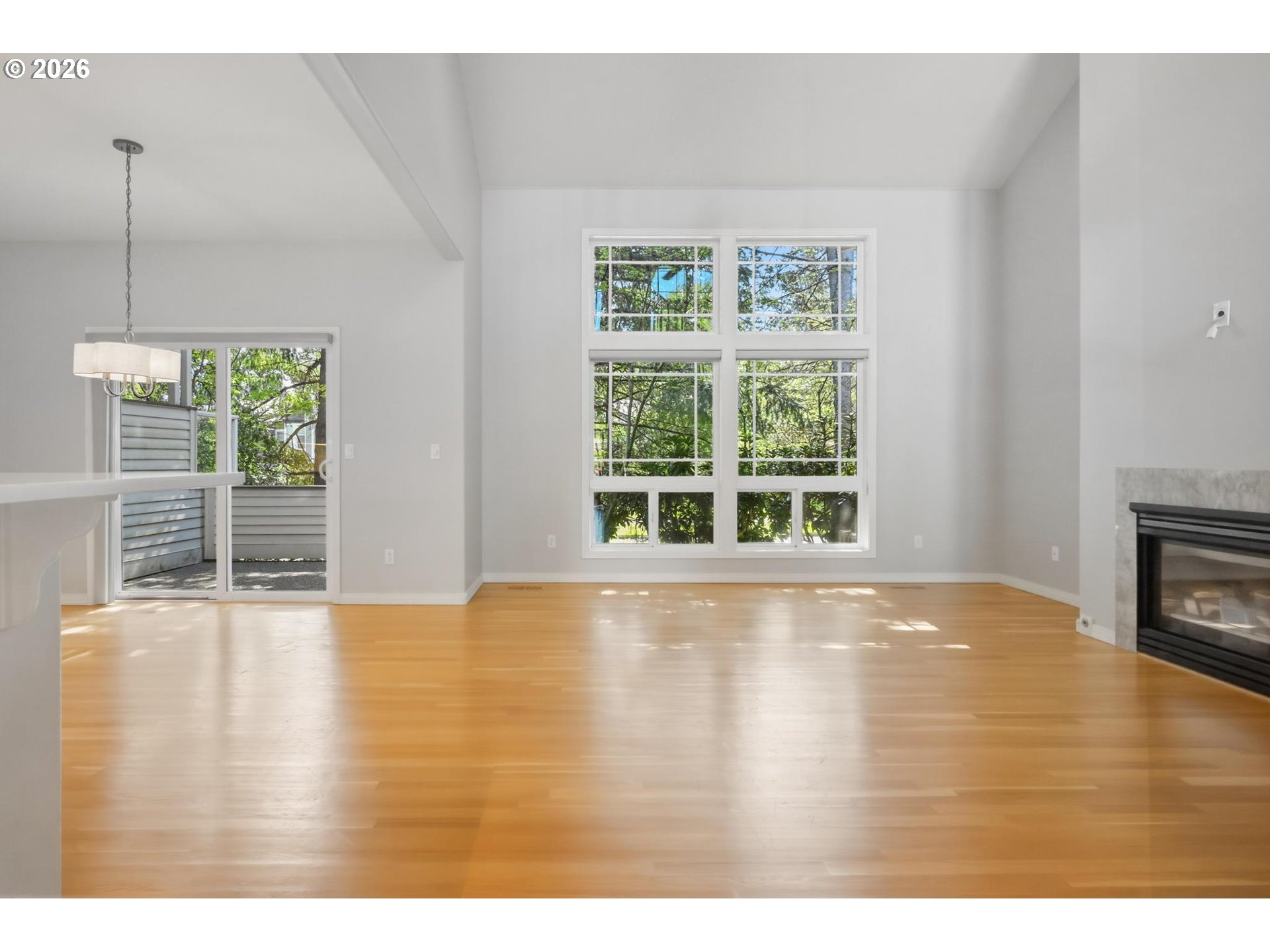 22215 Chelan Loop West Linn, OR 97068 - Photo 11 of 38 a view of an empty room with wooden floor and a window