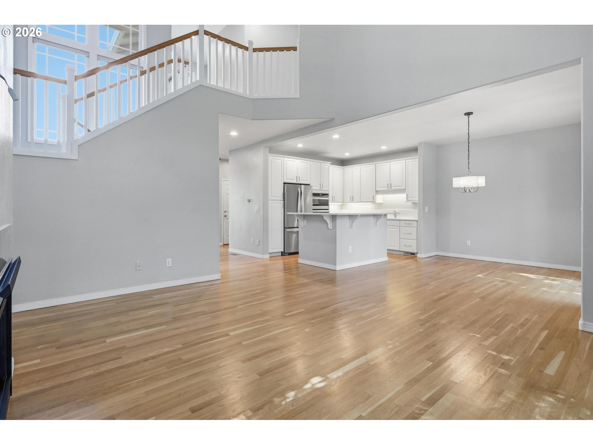 22215 Chelan Loop West Linn, OR 97068 - Photo 12 of 38 a view of kitchen and empty room with wooden floor