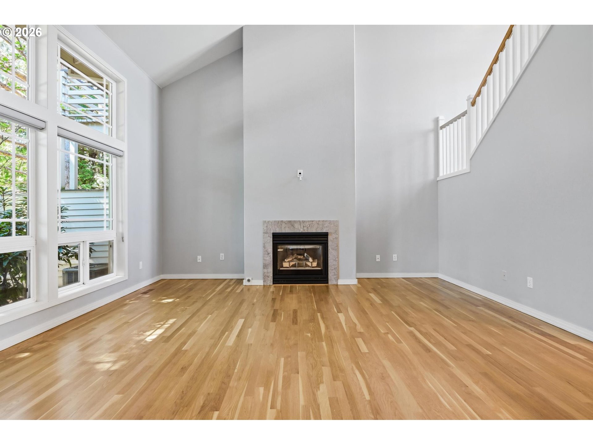 22215 Chelan Loop West Linn, OR 97068 - Photo 8 of 38 a view of an empty room with a window and wooden floor
