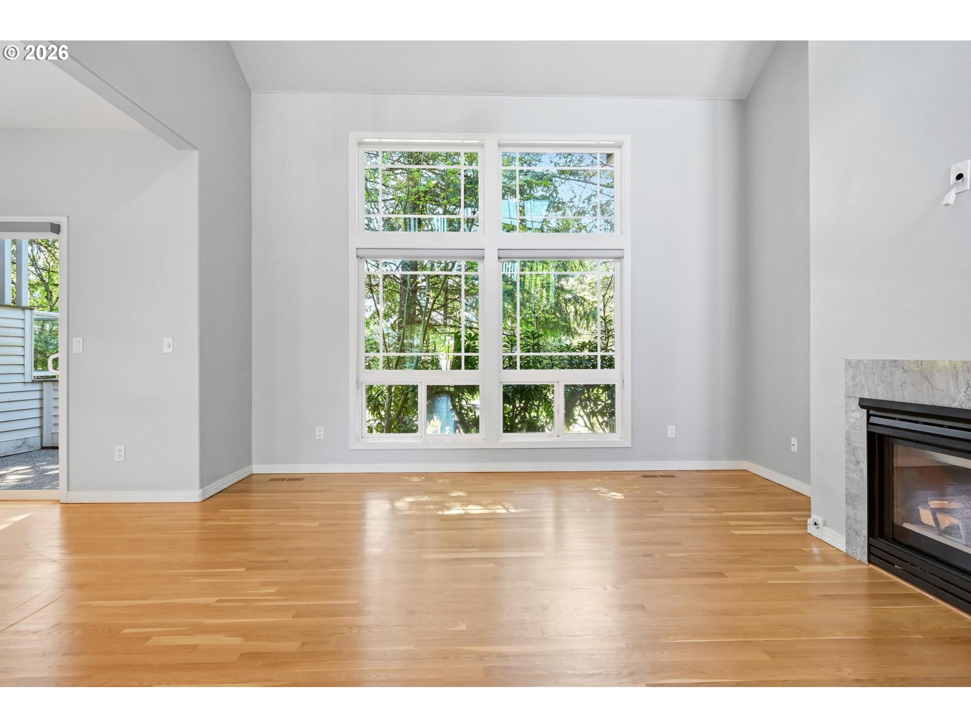22215 Chelan Loop West Linn, OR 97068 - Photo 10 of 38 a view of an empty room with wooden floor and a window