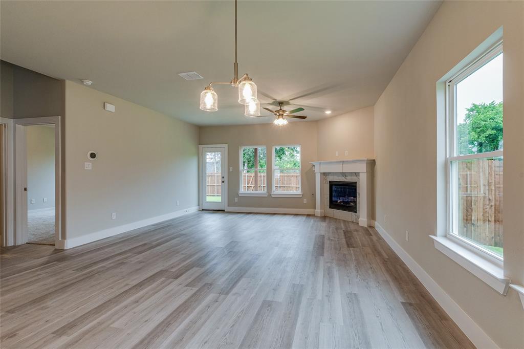 602 Kyle Drive Tioga, TX 76271 - Photo 11 of 29 a view of a livingroom with wooden floor fireplace and window