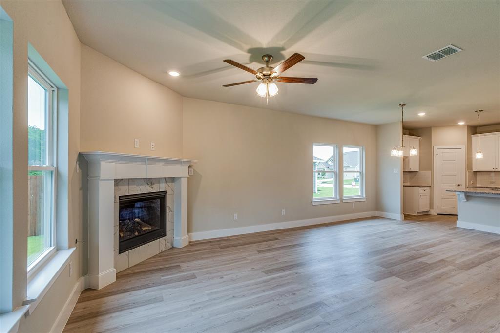 602 Kyle Drive Tioga, TX 76271 - Photo 15 of 29 a view of an empty room with wooden floor and a window