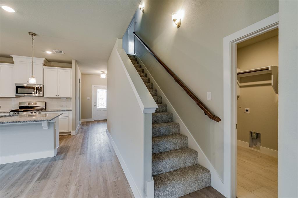 602 Kyle Drive Tioga, TX 76271 - Photo 16 of 29 a view of a kitchen with wooden floor electronic appliances and stairs