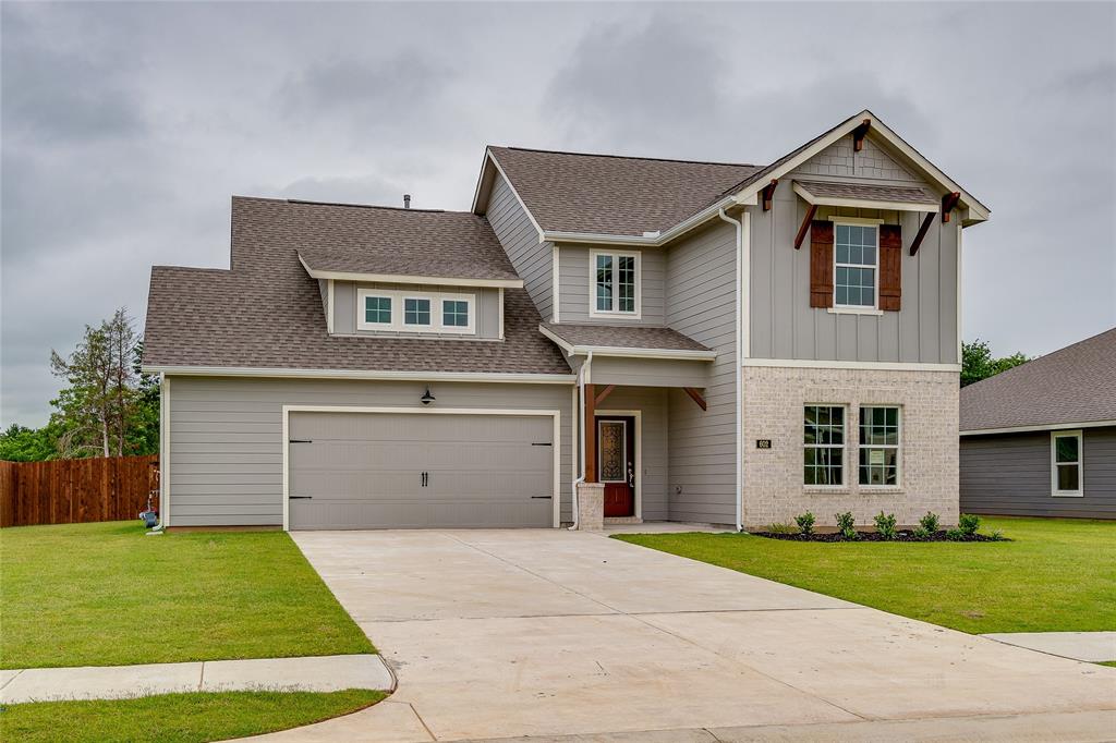602 Kyle Drive Tioga, TX 76271 - Photo 2 of 29 a front view of a house with a garden and yard
