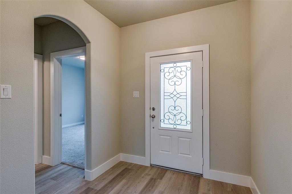 602 Kyle Drive Tioga, TX 76271 - Photo 5 of 29 an empty room with wooden floor closet and windows