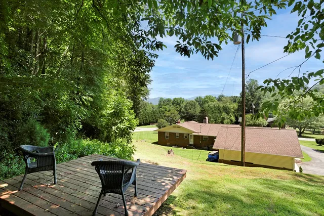 a view of a backyard with sitting area