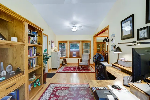 a living room with furniture and a book shelf
