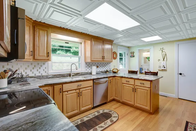 a kitchen with sink cabinets and wooden floor