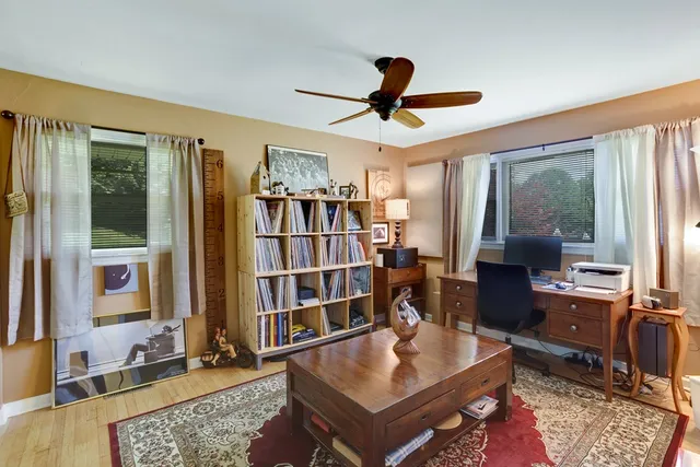 a living room with projector furniture and a rug