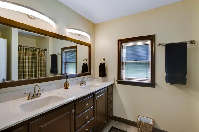 a bathroom with a double vanity sink and mirror