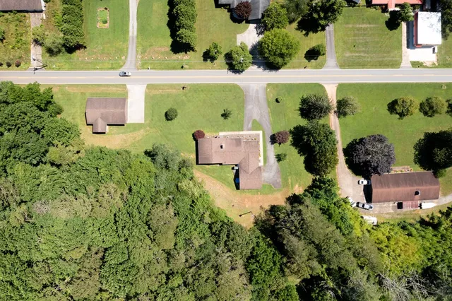 an aerial view of a house with a yard