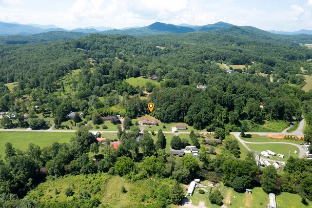 an aerial view of a town with residential houses outdoor and green space