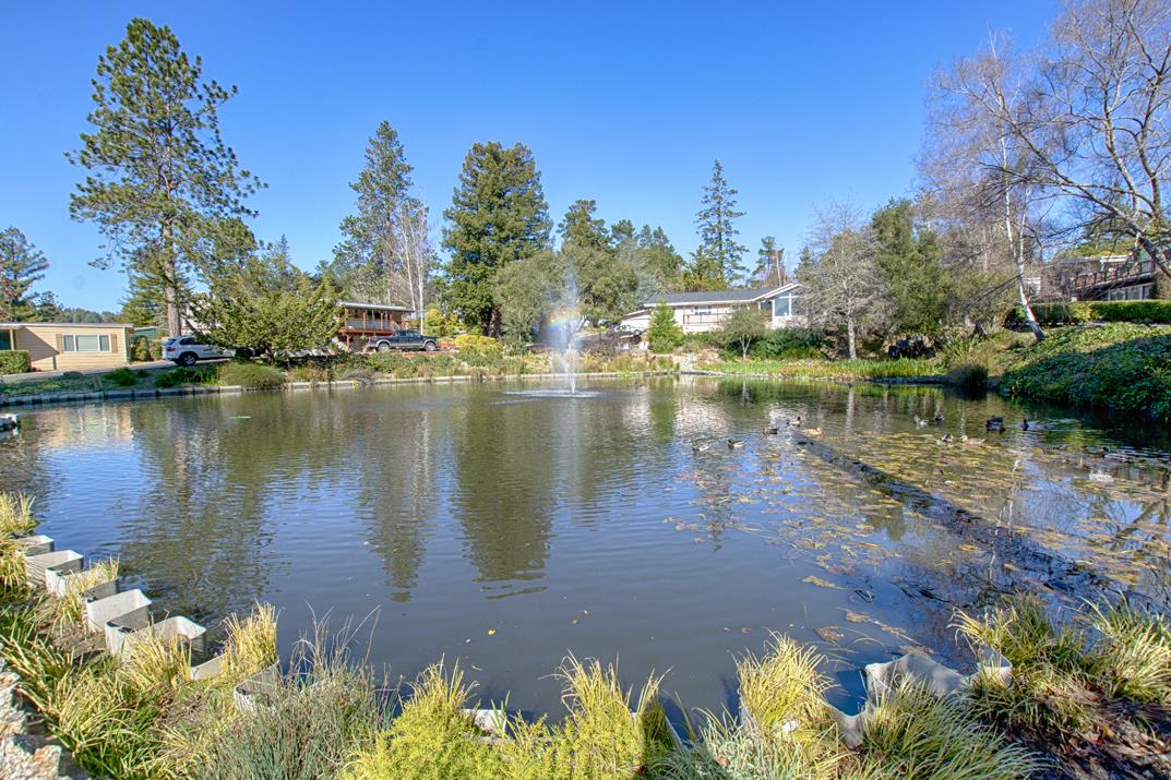 552 Bean Creek Road, Unit 57 Scotts Valley, CA 95066 - Photo 18 of 20 a view of a lake with a house in the background