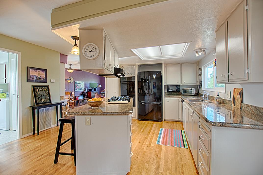 552 Bean Creek Road, Unit 57 Scotts Valley, CA 95066 - Photo 3 of 20 a kitchen with stainless steel appliances granite countertop a refrigerator and stove top oven