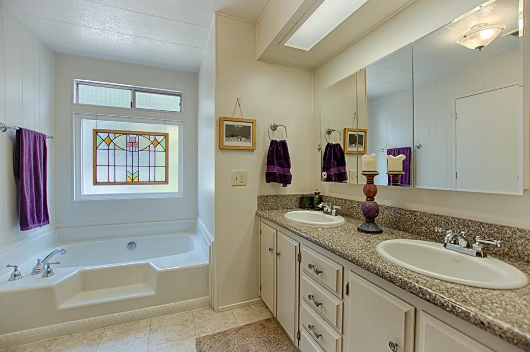 552 Bean Creek Road, Unit 57 Scotts Valley, CA 95066 - Photo 9 of 20 a bathroom with a granite countertop tub sink double vanity granite and a mirror