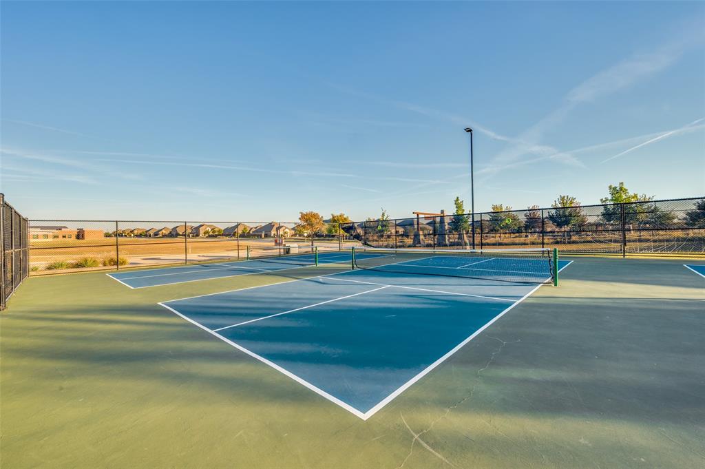 11105 Autry Ridge Lane Aubrey, TX 76227 - Photo 21 of 27 a view of an outdoor space and tennis court